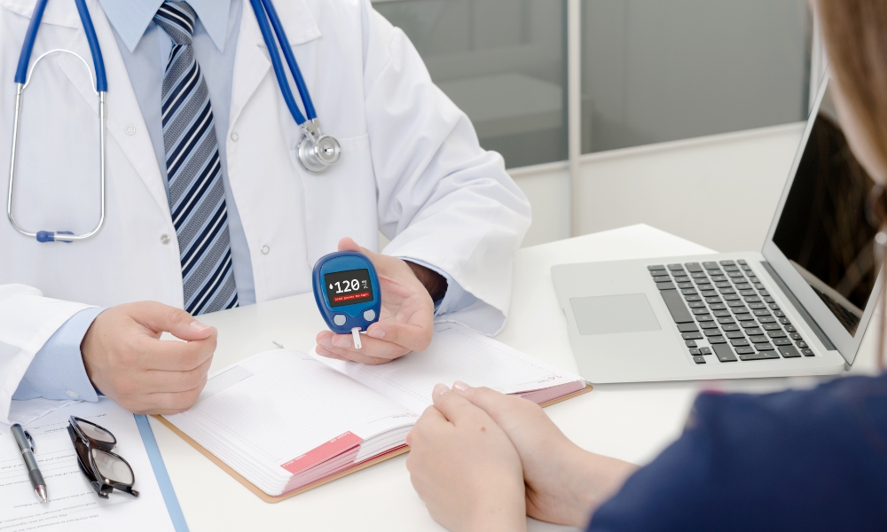 Primary care physician discussing Type 2 diabetes management, blood sugar monitoring, and A1C results with a patient in Round Rock Texas