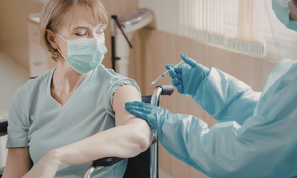 Primary care physician evaluating a patient with cough, congestion, sore throat, and fever to diagnose allergies, cold, flu, or COVID-19
