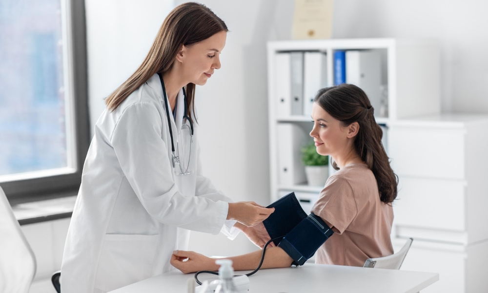 Patient using a home blood pressure monitor correctly to manage hypertension and track blood pressure readings