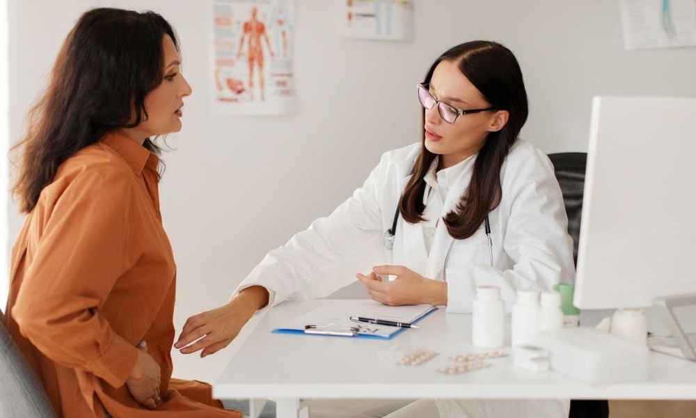Primary care physician evaluating an adult patient with stomach pain during a same-day clinic visit in Round Rock TX